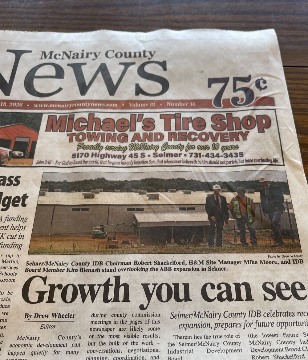 McNairy County News front-page feature, &lsquo;Growth you can see,&rsquo; showing IDB Chairman Robert Shackelford, H&M Site Manager Mike Moore, and IDB Board Member Kim Bienash overlooking the ABB expansion in Selmer